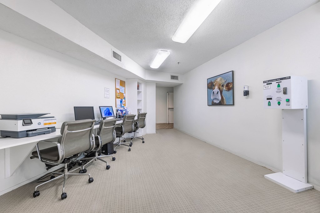 a conference room with chairs and desks and a printer