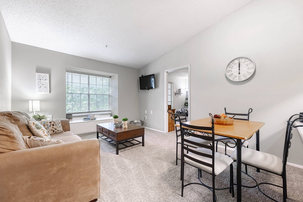 a living room with a dining room table and a couch