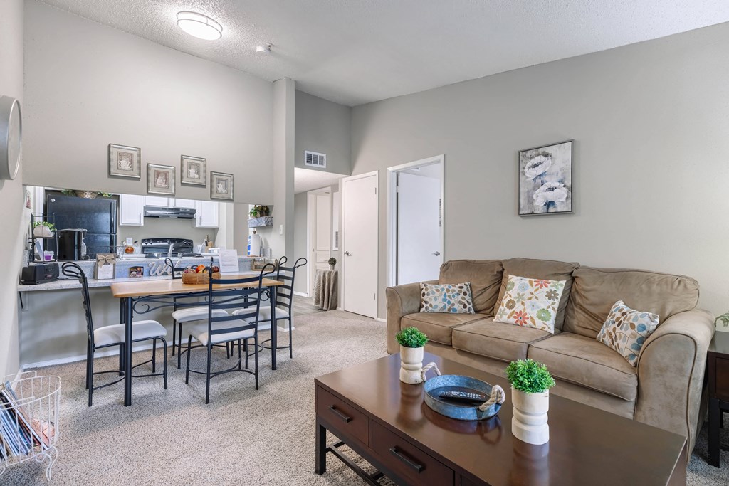 an open living room and kitchen with a couch and a table