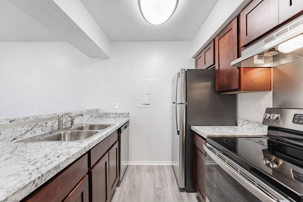 a kitchen with stainless steel appliances and marble counter tops