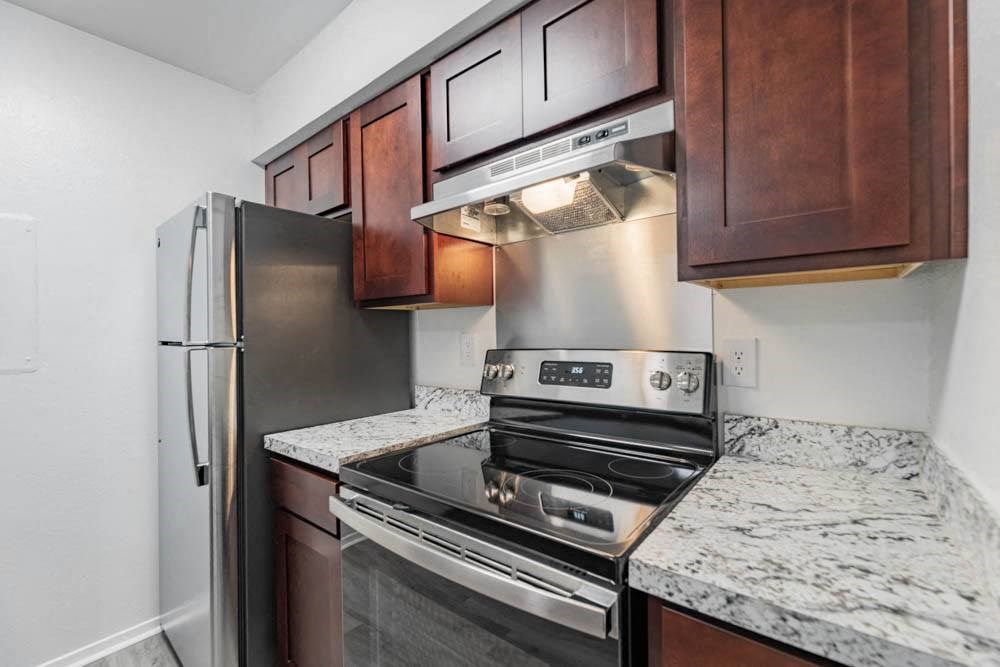 a kitchen with stainless steel appliances and granite counter tops