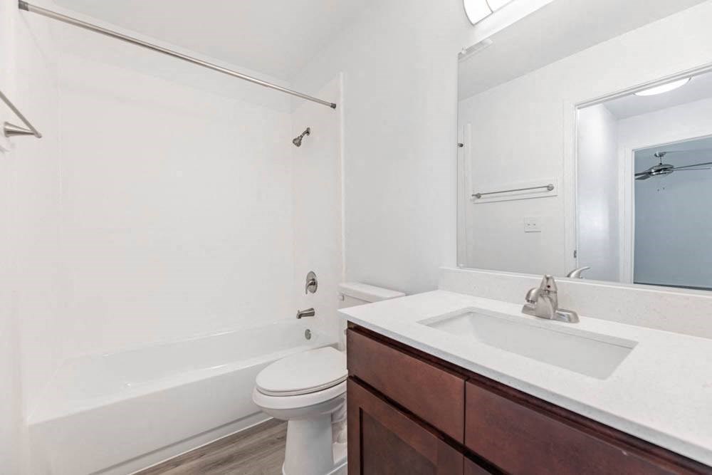 a bathroom with a sink toilet and a mirror