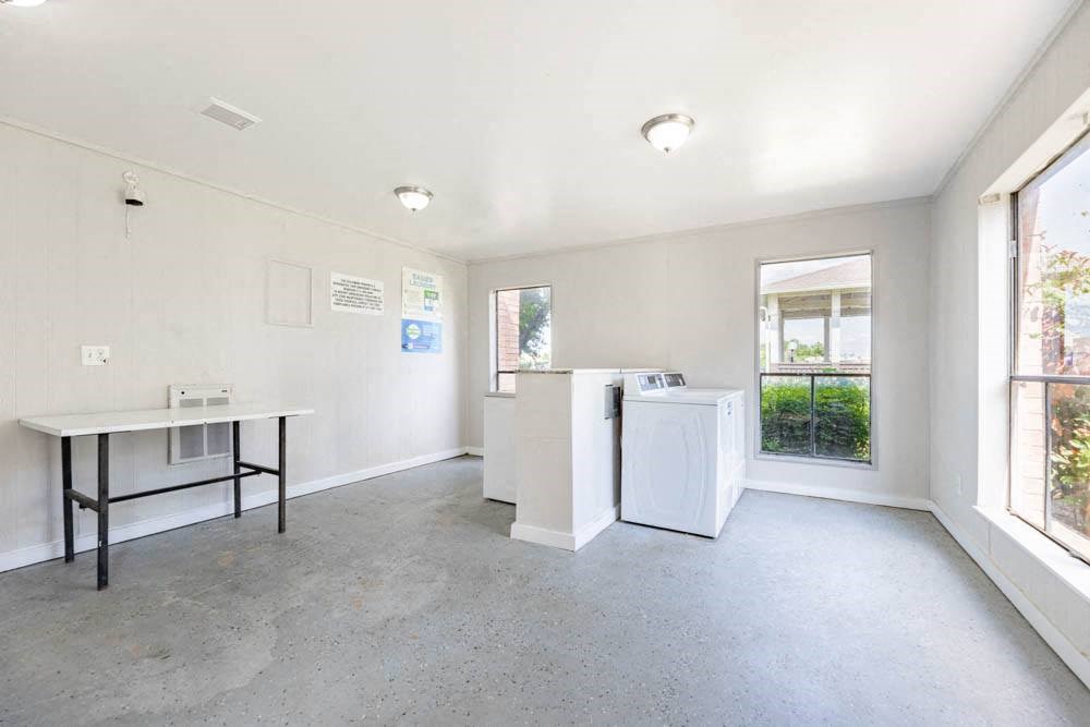 an empty room with washing machines and a counter