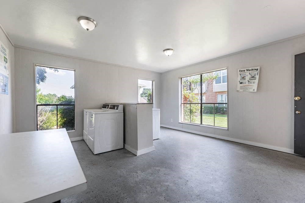 an empty room with a washer and dryer in it