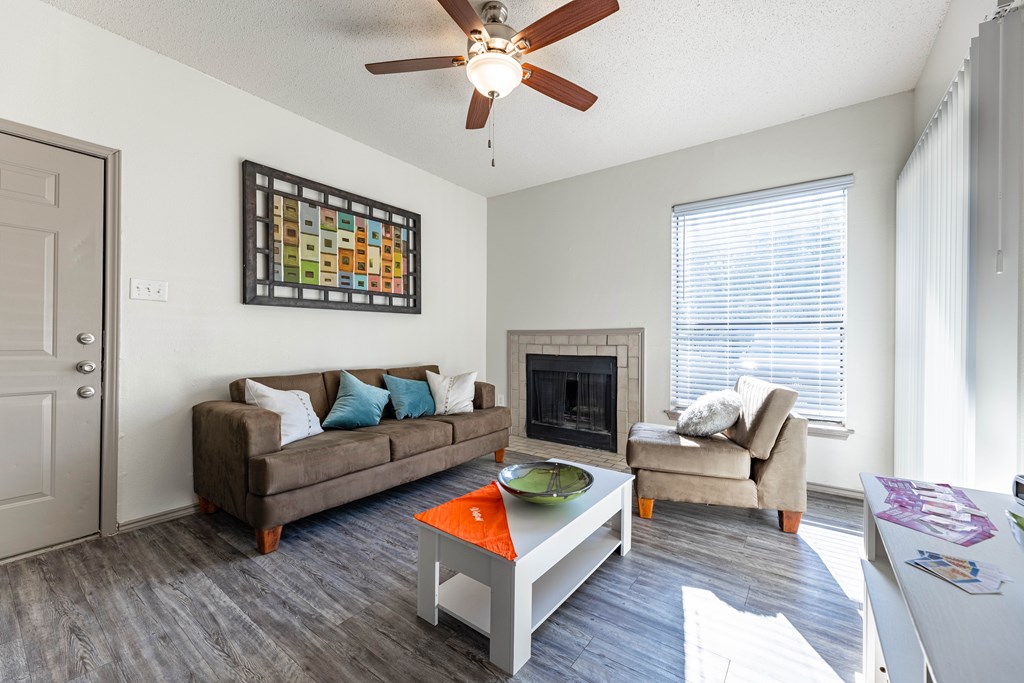 a living room with couches and a coffee table and a fireplace