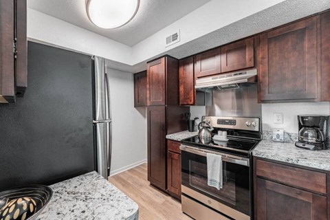 a kitchen with wooden cabinets and stainless steel appliances