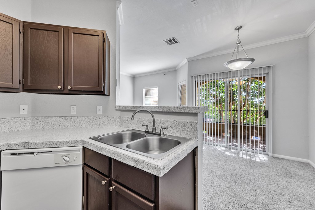 an empty kitchen with a sink and a window