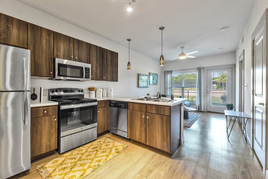 a kitchen with wooden cabinets and stainless steel appliances