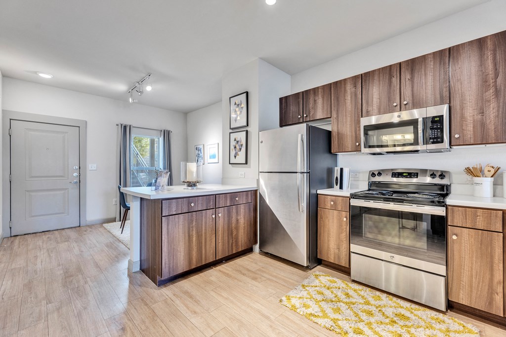 a kitchen with stainless steel appliances and wooden cabinets