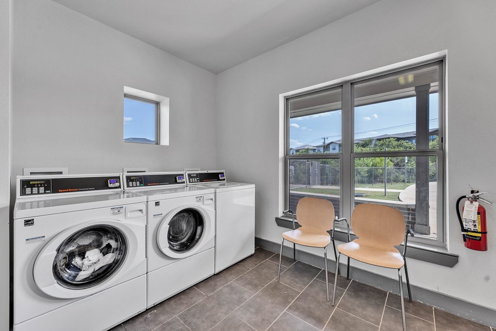 laundry room with washer and dryer and a window