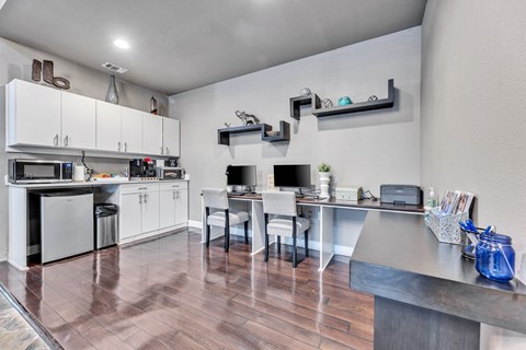 a kitchen with white cabinets and stainless steel appliances and a table with chairs