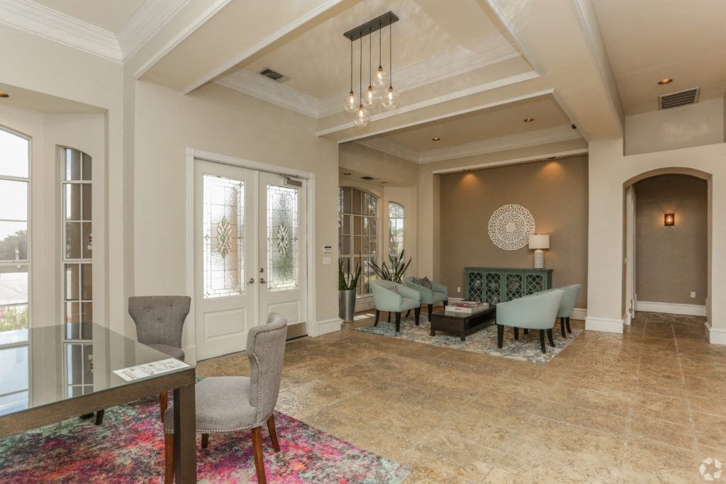 a dining room and living room with a table and chairs