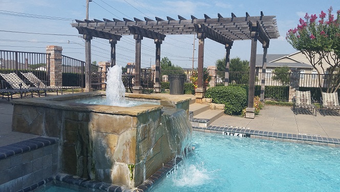 a swimming pool with a water fountain
