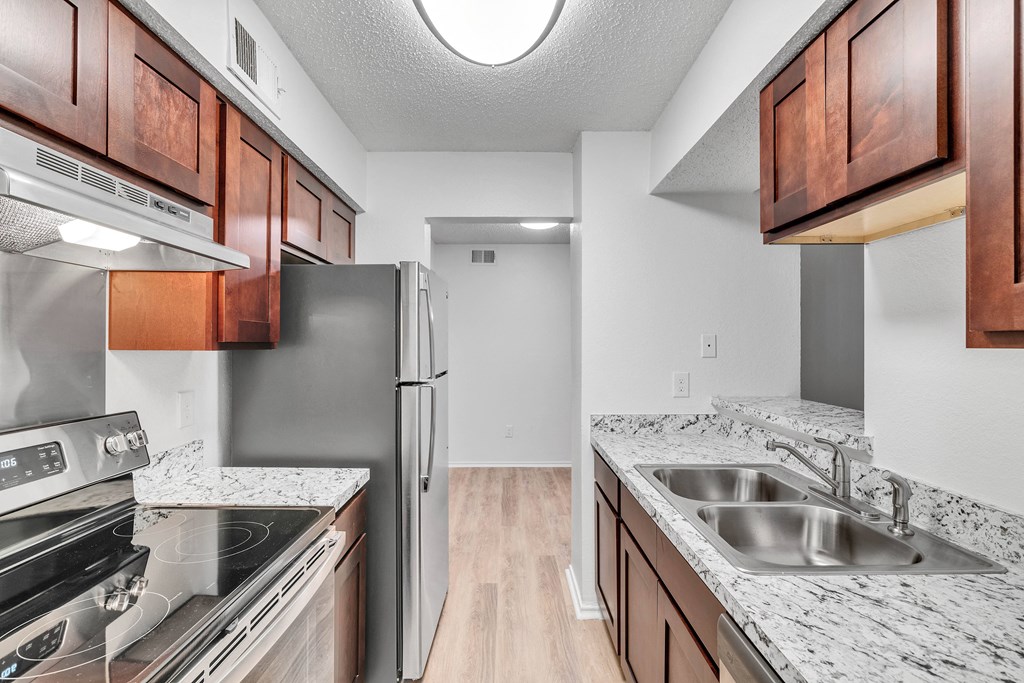 a kitchen with granite counter tops and stainless steel appliances