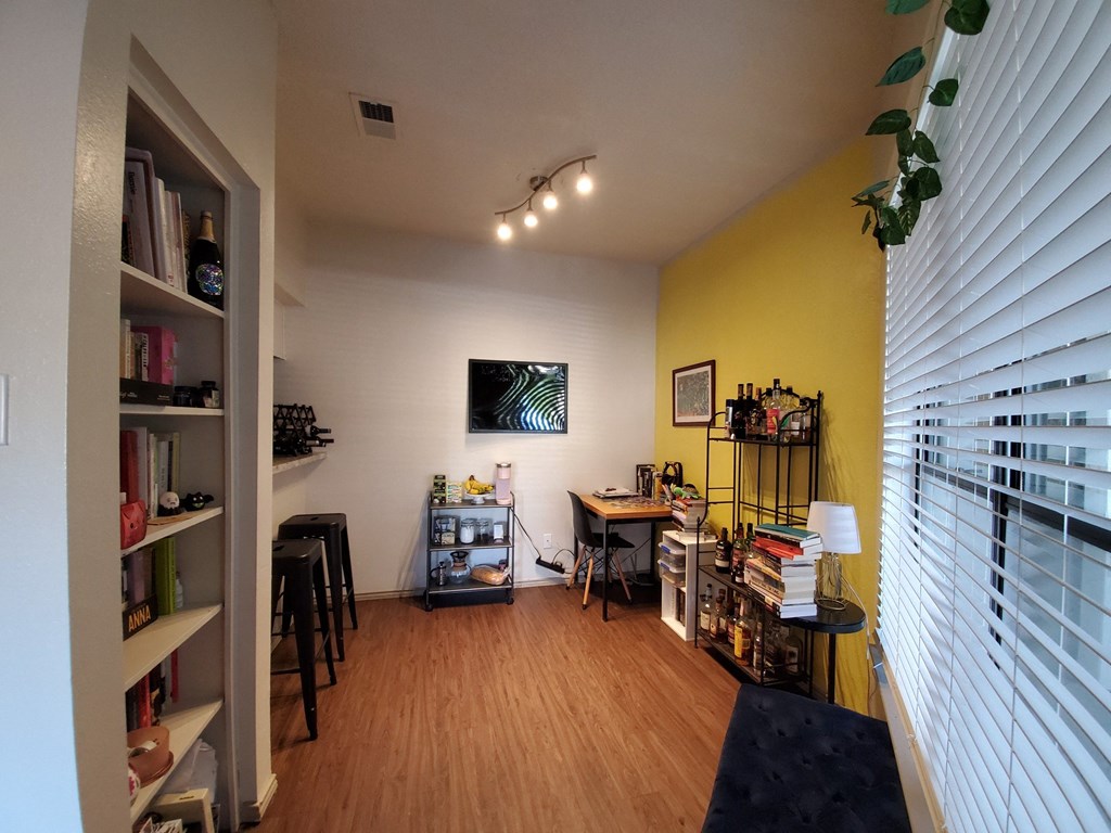 a room with a desk and a bookshelf