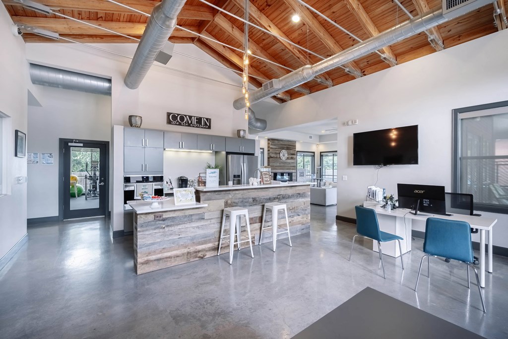 a kitchen and dining area with a bar and a television