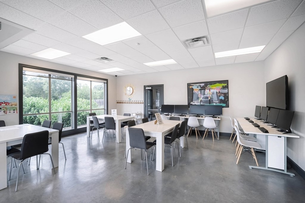 a dining room with tables and chairs and a tv