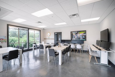 a dining room with tables and chairs and a tv