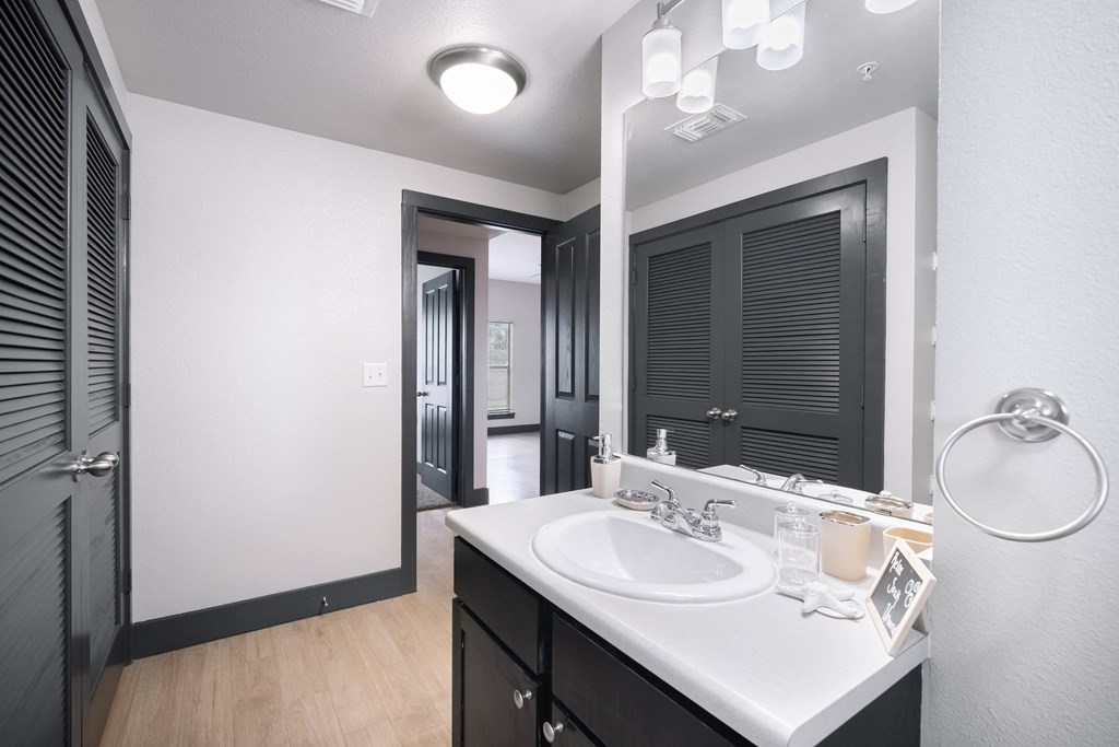 a bathroom with a large mirror and a sink