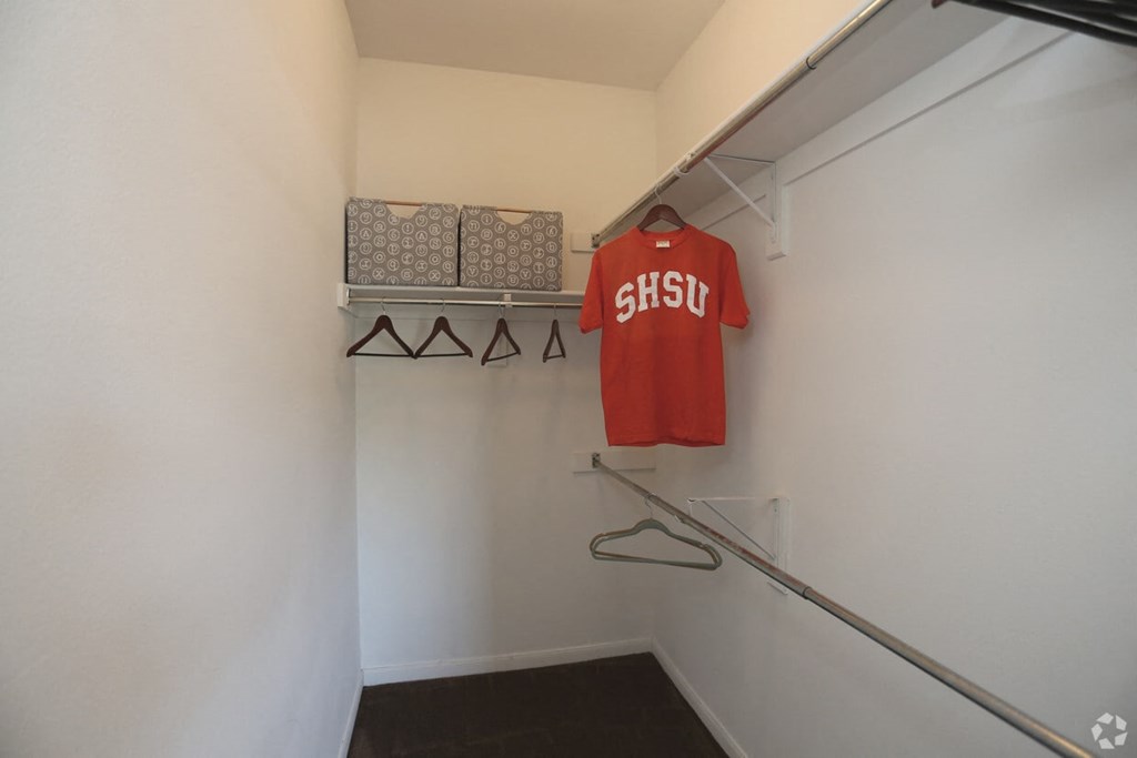 a bedroom with a medium sized closet and a large window