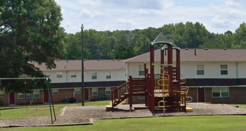 an image of a playground with a building in the background