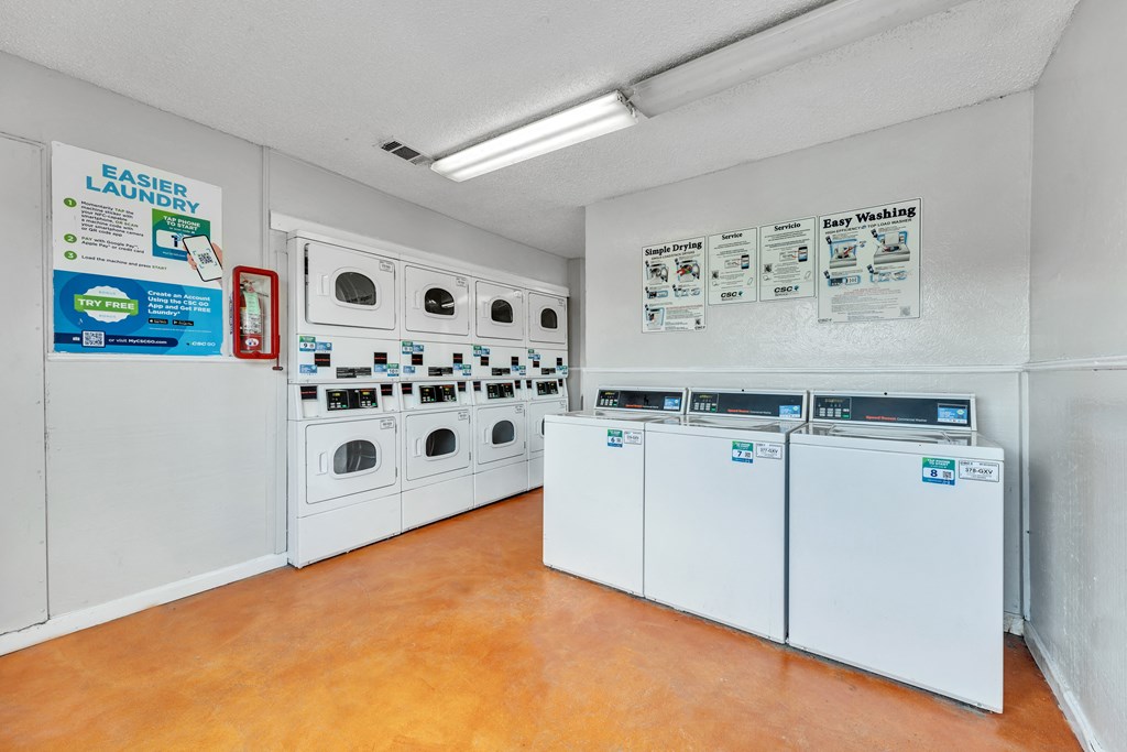 a laundry room with a bunch of washes and dryers in it