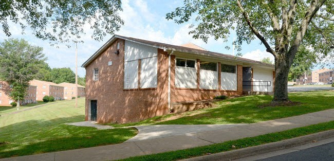 a house that has been boarded up with white curtains