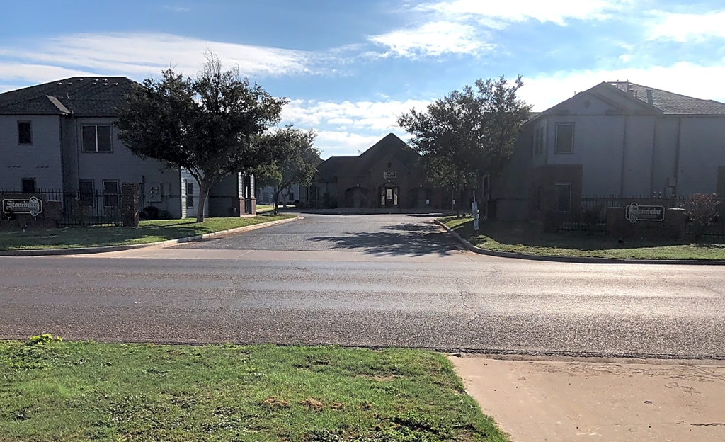a street in a neighborhood with houses and trees