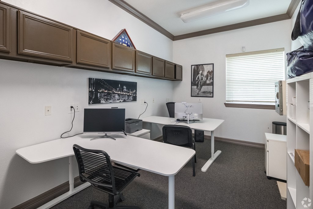 an office with two desks and a computer