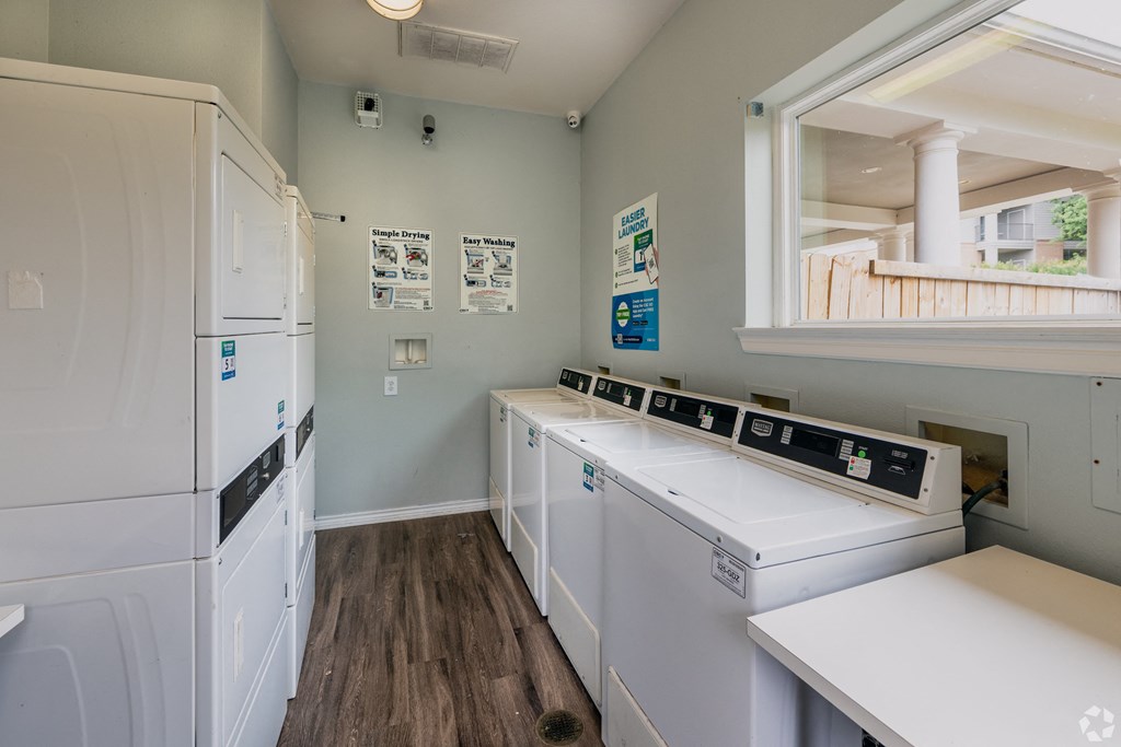 a laundry room with two washes and two sinks and a refrigerator