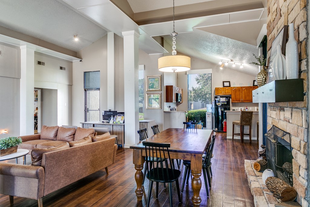 a living room with a fireplace and a dining table