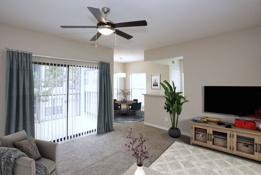 a living room with a ceiling fan and a large window - Photo Gallery