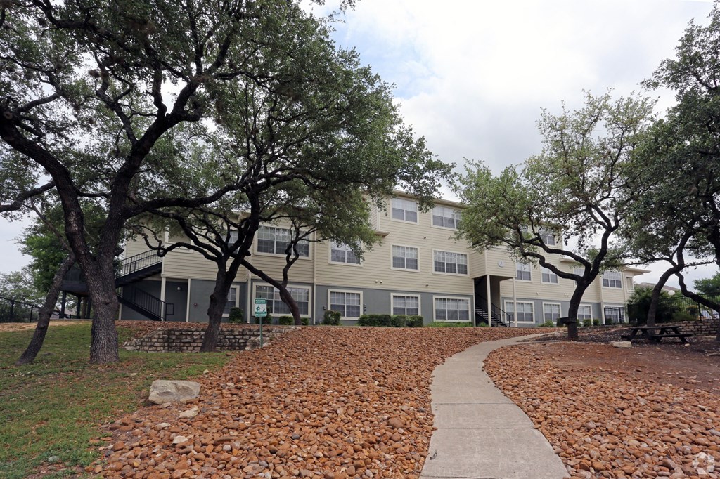 our apartments have a walkway with trees in front of them