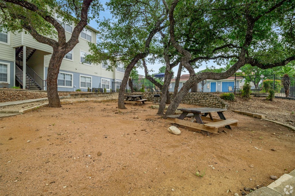 a picnic table in a park next to a building