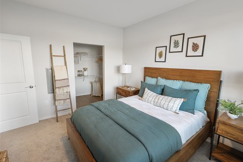 a bedroom with a large bed and closet