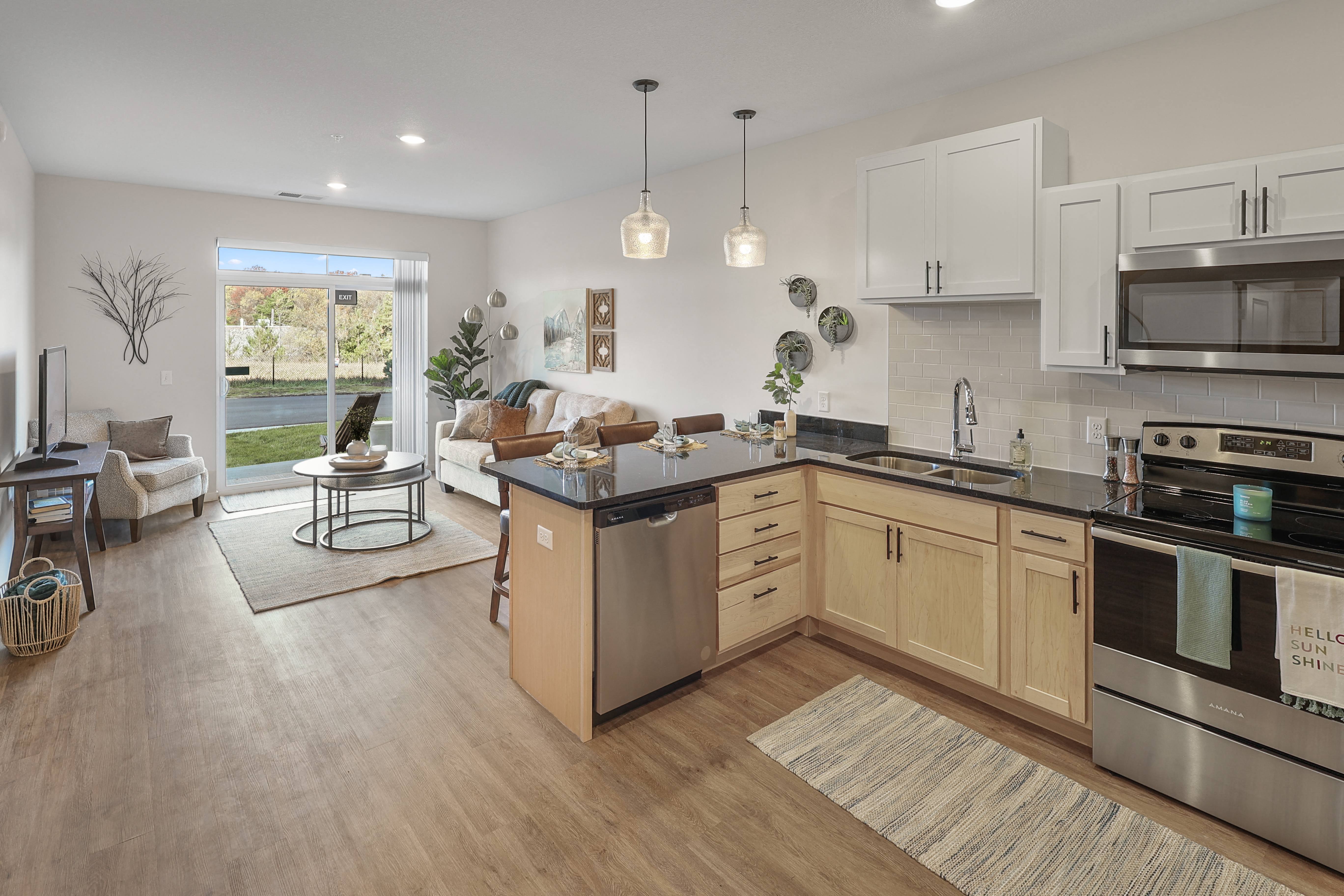 an open kitchen and living room with a couch and a table