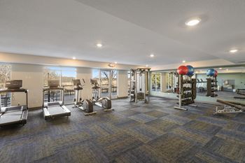Auora Vista fitness center with exercise equipment and windows