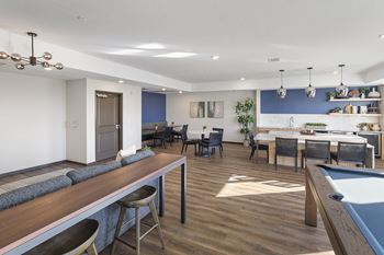 a communal area with a pool table and a dining room