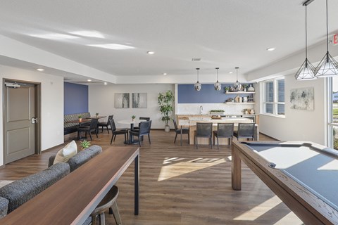 a clubroom with a pool table and a dining table