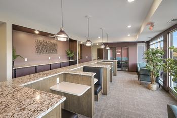 a communal kitchen and dining area in a modern office building