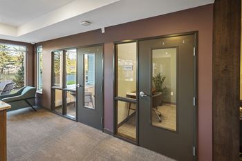 a conference room with sliding glass doors and a table and chairs