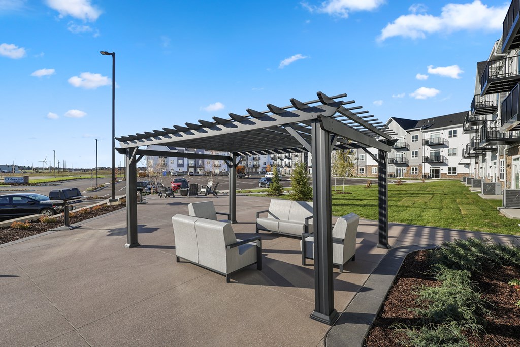 a patio with chairs and a table under awning