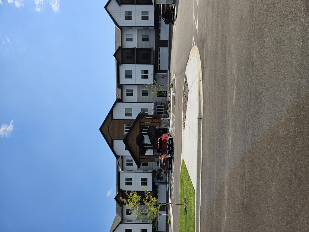 A fire truck is parked in front of a white building.