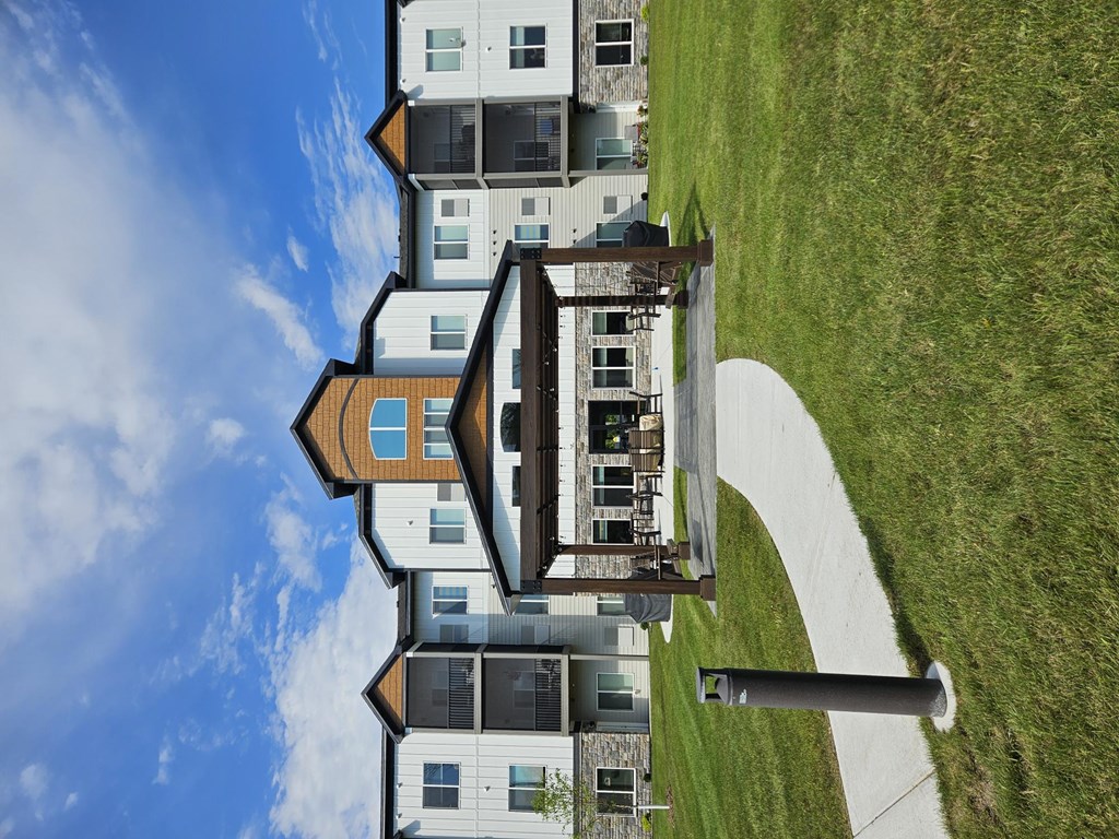 A modern building with a green lawn in front.