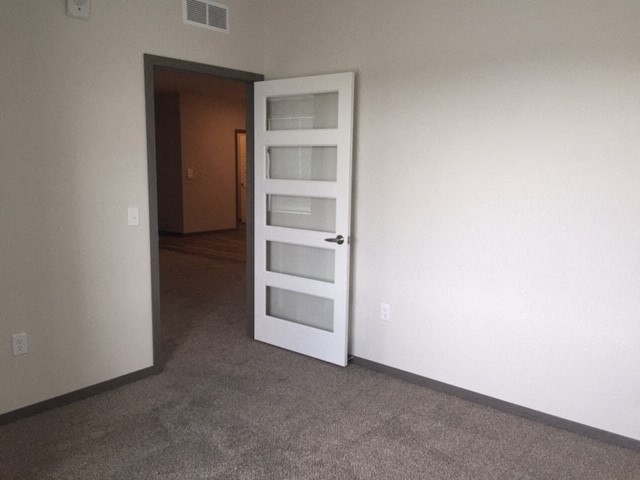 an empty room with an open white door