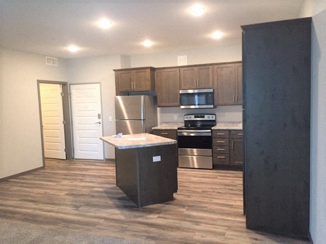 a kitchen with a counter in the middle of it