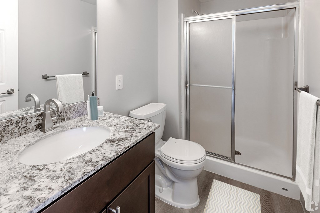 a bathroom with a sink toilet and shower