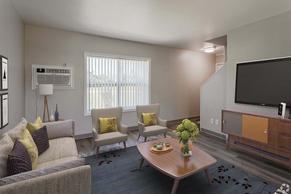 a living room with couches and chairs and a television