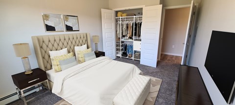 A bedroom with a large bed and a walk-in closet.