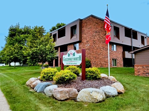 A brick building with a sign that says Greenway North.